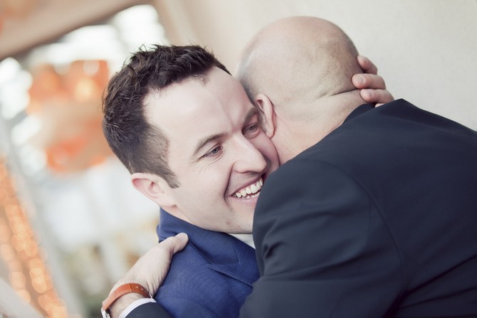 groom hugging best man 