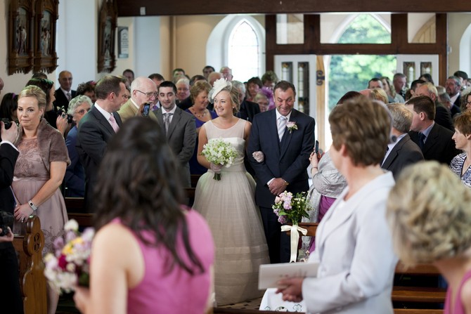 bride and father walking up aisle