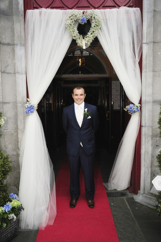 groom outsde church photo