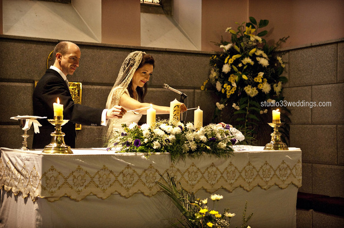 bride and groom lighting candles